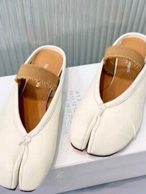 White split-toe leather mules with frayed strap